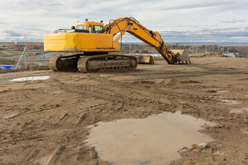 Obraz premium Excavator at a construction site, performing earth moving work