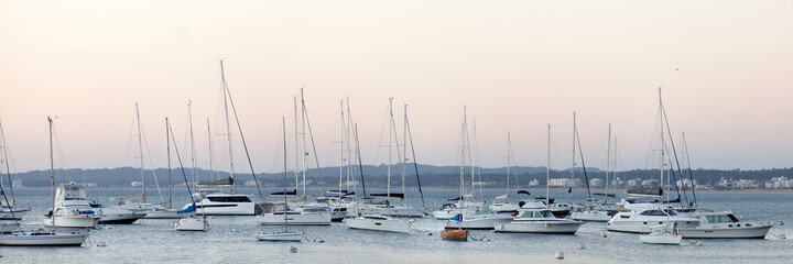 Naklejka na ściany i meble yachts in the harbor. vacations, boats and sunset. panorama.