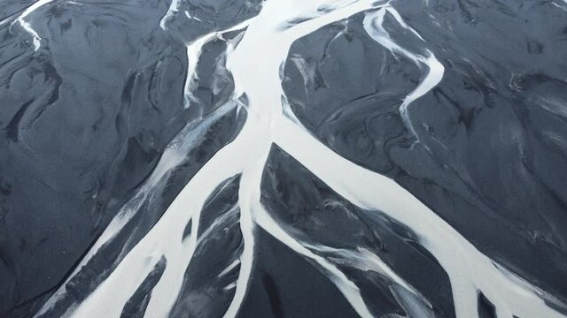 Aerial view of patterns of Icelandic rivers flowing into the ocean, Unusual beautiful landscape, Iceland in early spring, Clean water and untouched nature