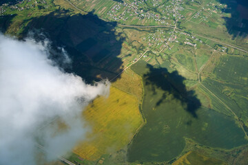 Aerial view from high altitude of earth covered with white puffy cumulus clouds on sunny day