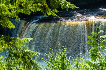 Waterfall - powerful water flowing Into the river - Tahquamenon Falls Northern Michigan Late Summer, medium view.