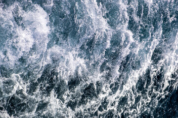 Fototapeta na wymiar Top down aerial view of sea water surface. White foam waves texture as natural background.