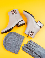 fashion accessory. pair of fashionable leather shoes and hat. beige boots and gloves.