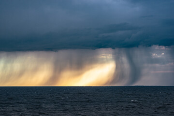 Dramatic image of fallstreaks of rain and hail below the base of thunderstorm over lake IJsselmeer in The Netherlands
