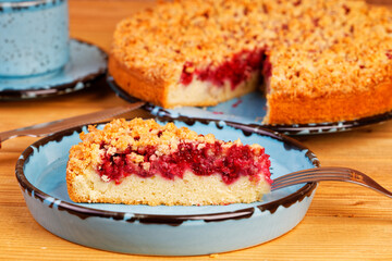 Closeup piece of homemade raspberries pie with streisel. Shallow focus.