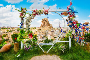 Kapadokya swings empty on viewpoint to Ortahisar castle with beautiful spring flower decorations