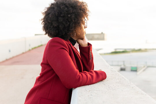 Black woman with Afro hairstyle on embankment of river