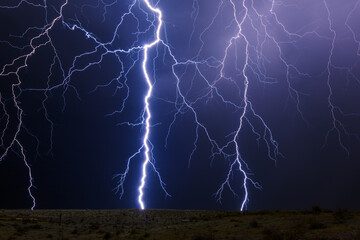 Lightning bolt strike from a storm in the night sky