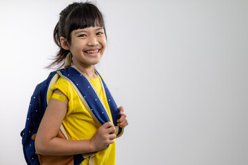  Asian young girl showing her arm with yellow bandage after got vaccinated or inoculation, child immunization, covid delta vaccine concept