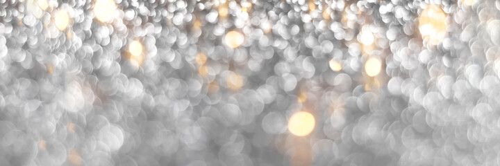 Silver and golden sparkling glitter bokeh background, christmas texture. Holiday lights. Abstract defocused header. Wide screen wallpaper. Panoramic web banner with copy space for design