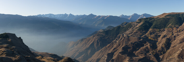 Panoramic photo of the mountain ranges of the Caucasus. A fabulous morning in the mountains. Beautiful nature. Travel and hiking.