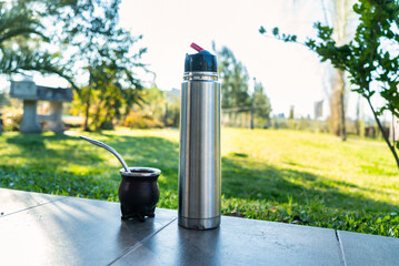mate and thermos ready to drink in the garden on a beautiful spring day.
