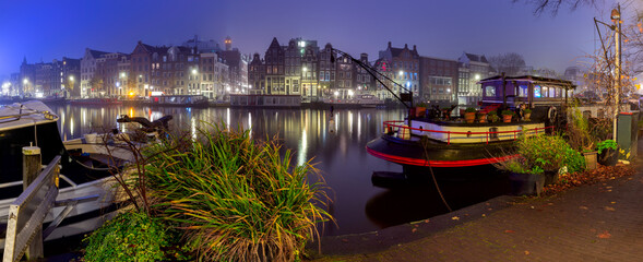 Panorama of the city waterfront of Amsterdam on a foggy morning. - obrazy, fototapety, plakaty