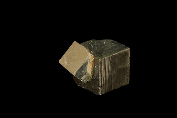 Macro mineral stone Pyrite on a black background