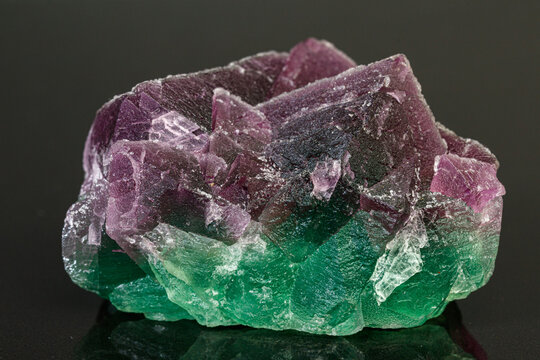 macro mineral stone green and purple fluorite on a black background