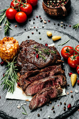grilled steak Ribeye Black Angus medium rare beef. vertical image. top view. place for text