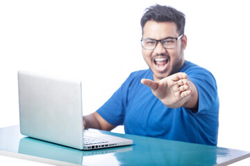 young boy using laptop and showing empty hand with screaming expression