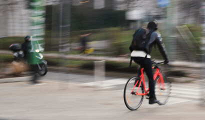 Fototapeta na wymiar cyclist orange bike motion blur