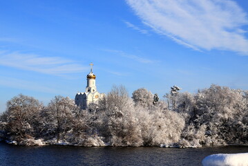 Winter Christmas landscape. Christian Orthodox Church on island of the Dnieper River, covered with ice and snow in winter. Ukraine, Dnipro city Dnepropetrovsk