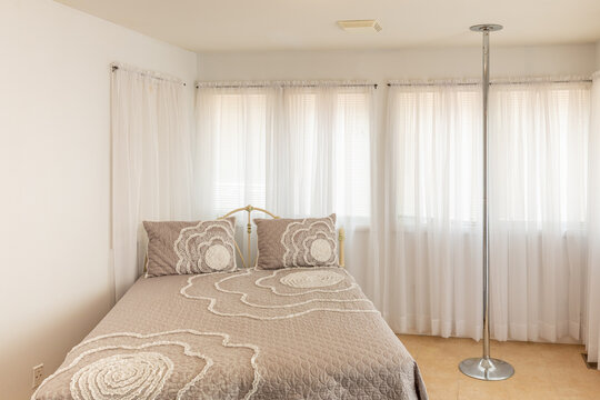 Bedroom with stripper pole