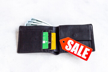 Price sale label and wallet with banknotes and bank cards