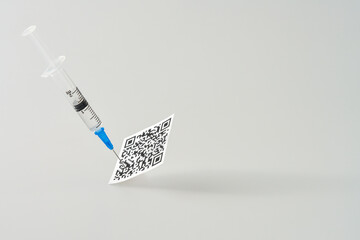 A syringe with a vaccine in the vaccination certificate on a white background.