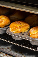 Individual Yorkshire puddings cooking in an electric oven.  Traditional British food concept