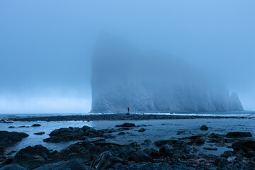 Perce Rock with human silhouette standing in front