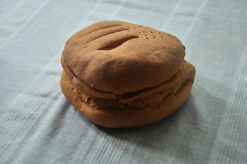 homemade bread on the table. freshly baked loaf on a white tablecloth. food concept. odorous bun on a white 