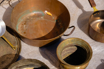 Old copper utensils at a flea market in Provence. Flea market tourism.