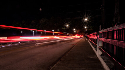 Fototapeta na wymiar Light streaks from cars on bridge