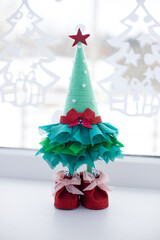 DIY Christmas tree with your own hands. A Christmas tree made of waste. Reuse of waste. Saving resources. Vertical photo. Space for text. Selective focus. 