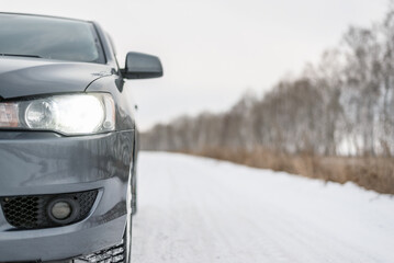 Car travel concept. Car on the empty snowy road background.