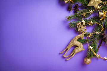 Purple Christmas and New Year background with decorated fir tree, golden deer and ornaments. Space....