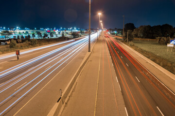 Night wiew of a straight stretch of a highway with light trails left by passing vehicles