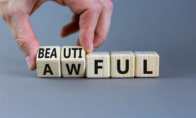Beautiful or awful symbol. Businessman turns wooden cubes, changes the word Awful to Beautiful. Beautiful grey background, copy space. Business, psychological beautiful or awful concept.