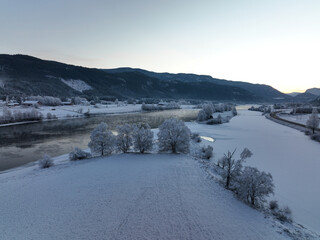 Drone photo fra Hallingdal, Nesbyem. The river is freezing but it is warmer than the air. Frost smoke. 