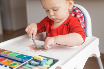 18 month old toddler drawing and painting with two hands at once; watercolor paint and chalk pastel...