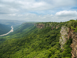 Fototapeta na wymiar Oribi Gorge lush jungle river and sand stone rock face