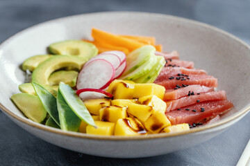 Healthy buddha bowl with raw tuna and vegetables