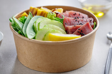 Healthy buddha bowl with raw tuna and vegetables