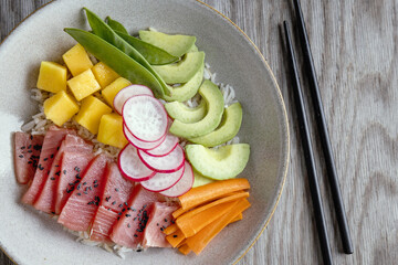 Healthy buddha bowl with raw tuna and vegetables