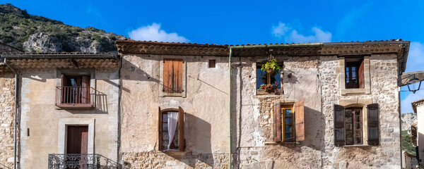 Saint-Guilhem-le-Desert in France, view of the village, typical street and houses
