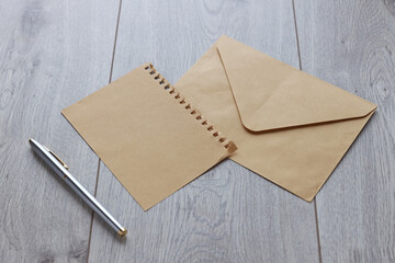 write letter envelope. craft envelope on a wooden table and pen nib