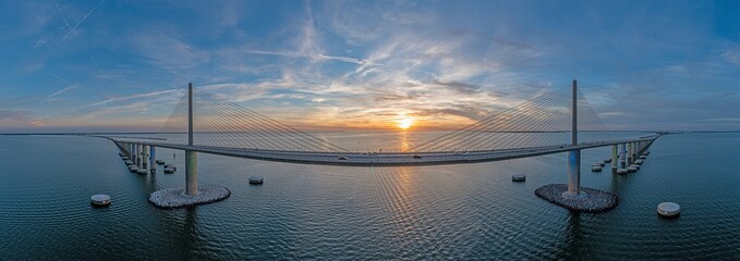 Drone panorama of Sunshine Skyway Bridge over Tampa Bay at sunset - obrazy, fototapety, plakaty