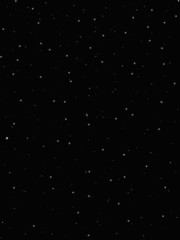 Dark background. Snow on a dark background. White round snow. Falling snow. The background is New Year's or Christmas. Overlays.
