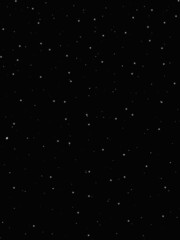 Dark background. Snow on a dark background. White round snow. Falling snow. The background is New Year's or Christmas. Overlays.