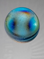 Blue glass marble on light table