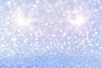 Abstract festive sparkling background with bokeh and sparklers. Brilliant bokeh of stars and fireworks