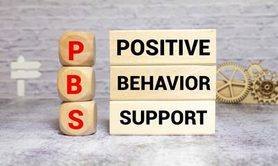 Positive behavior support symbol. Concept words Positive behavior support on wooden blocks.